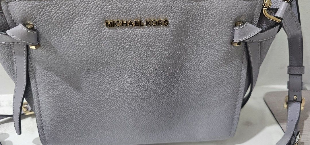 Michael Kors Grey Leather Handbag with Embellished Strap lp supee marked down (Category: Luxury Bags & Wallets) located in Davao. Submitted by sachigo (Listing ID 1463801429, Image 2). Description: - Genuine grey leather Michael Kors handbag - Detachable strap with beautiful floral and stud embellishments - Elegant gold hardware accents - Multiple interior compartments for organization - Clean interior, ready for its new owner - Versatile for bot