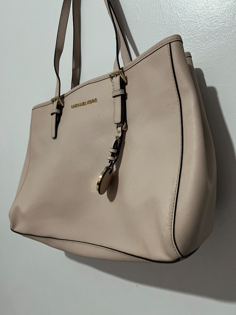 Michael Kors Tote Bag - Beige (Category: Tote Bags) located in Davao. Submitted by jpnusapasabuyfindsdvo (Listing ID 1463880438, Image 3). Description: Michael Kors Jet Set Travel Medium Saffiano Leather Tote (Beige/Nude) - NEVER USED, BOUGHT FROM US - Authentic Michael Kors tote bag - Elegant beige color - Classic design - Shiny gold hardware details - Iconic MK charm on strap - Ample interior space for essentials - Ideal for everyday use and tr