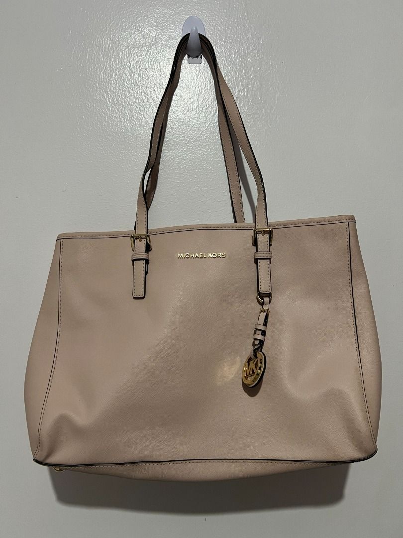 Michael Kors Tote Bag - Beige (Category: Tote Bags) located in Davao. Submitted by jpnusapasabuyfindsdvo (Listing ID 1463880438, Image 2). Description: Michael Kors Jet Set Travel Medium Saffiano Leather Tote (Beige/Nude) - NEVER USED, BOUGHT FROM US - Authentic Michael Kors tote bag - Elegant beige color - Classic design - Shiny gold hardware details - Iconic MK charm on strap - Ample interior space for essentials - Ideal for everyday use and tr