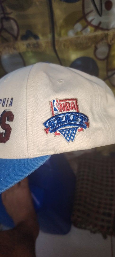Mitchell & Ness Philadelphia 76ers NBA Draft Cap (Category: Caps & Hats) located in Manila. Submitted by uncledreww22 (Listing ID 1463930470, Image 1). Description: - Mitchell & Ness Philadelphia 76ers Cap - Features NBA Draft logo on the side - Classic white and blue colorway - Perfect for any 76ers fan - Shows some signs of wear on brim and inside.