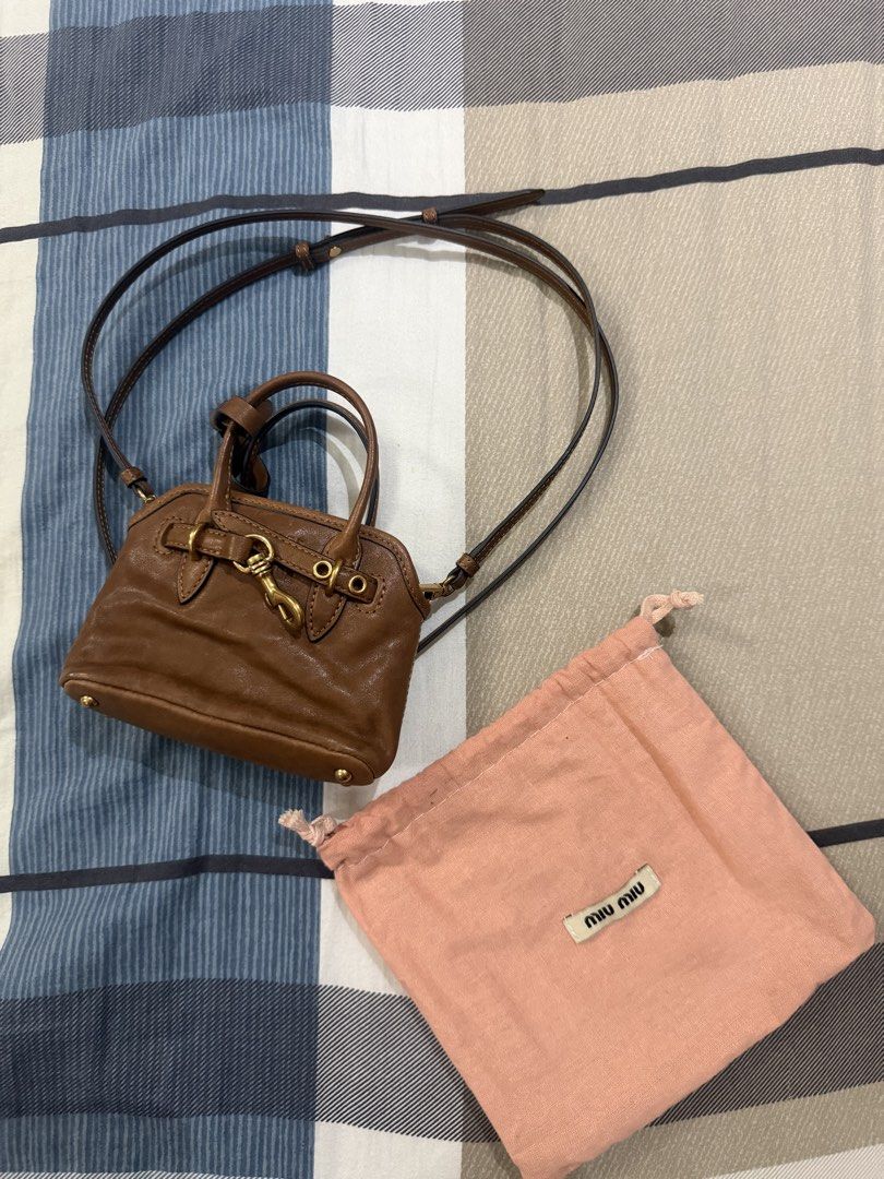 Miu Miu Micro Bag (Category: Luxury Bags & Wallets) located in Rizal. Submitted by caintarizal2024 (Listing ID 1463787105, Image 2). Description: Miu Miu Leather Handbag Miu Miu Brown Leather Mini Handbag Decluttering / letting go of this beautiful piece. • Authentic-looking Made in Italy label • Rich cognac/brown leather • Gold-tone hardware • Top handle + long crossbody strap • Comes with Miu Miu dust bag • Compact and elegant — perfect for eve