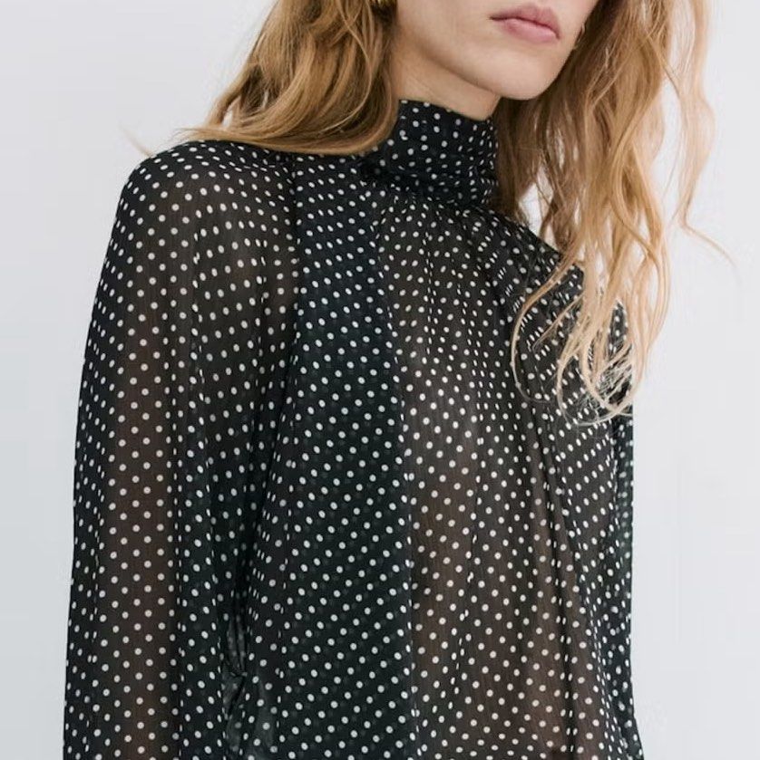 MNG Black Polka Dot High Neck Sheer Blouse (Category: Blouses) located in Manila. Submitted by .yansells (Listing ID 1463928971, Image 2). Description: - Chic black sheer blouse - Adorable white polka dot pattern - Elegant high neckline with tie detail - Long sleeves with ruffled, tieable cuffs - Lightweight and flowy material - Perfect for layering or as a standalone statement piece - Fits M-semi XL.