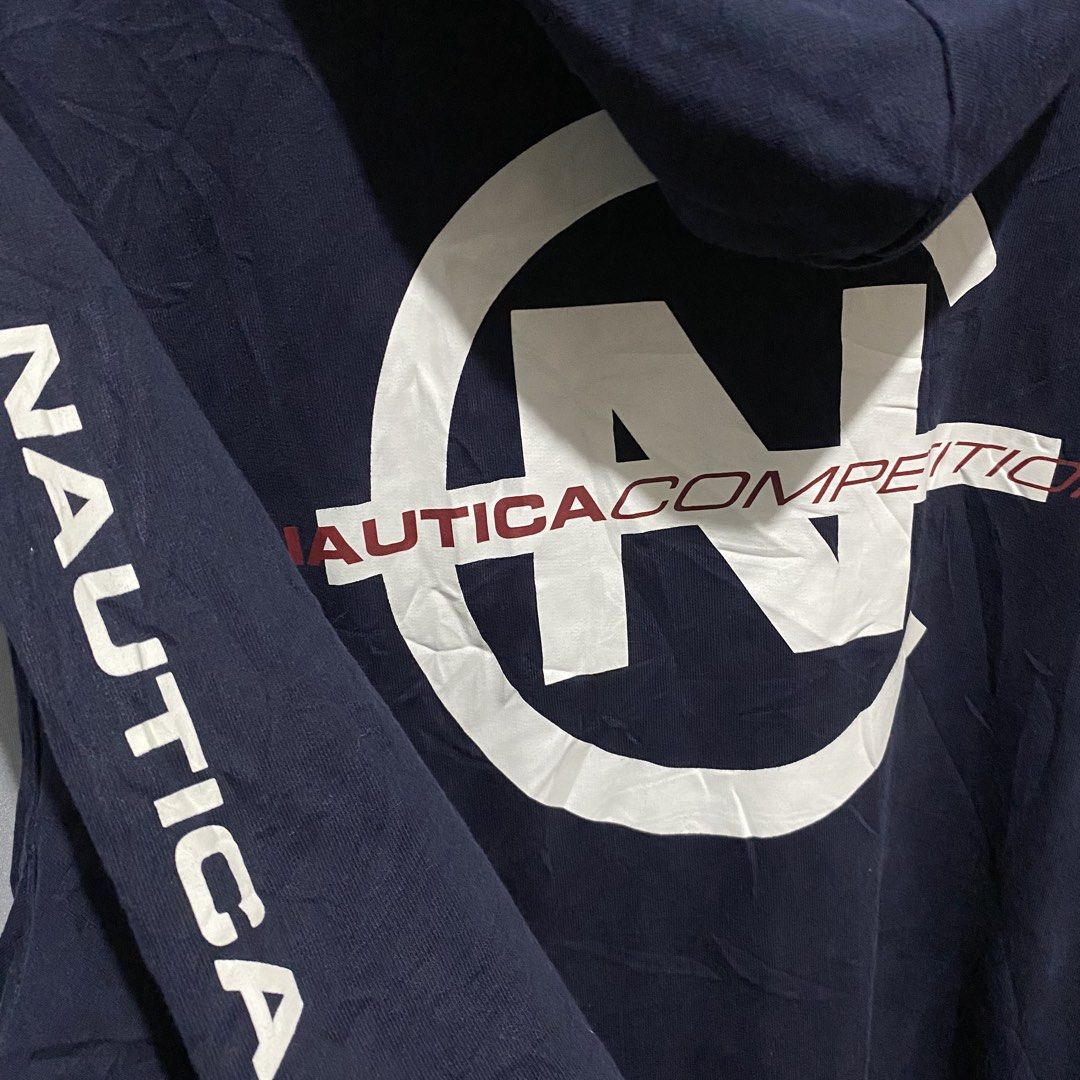 Nautica (Category: Coats, Jackets and Outerwear) located in Baguio. Submitted by loc_bc (Listing ID 1463901327, Image 3). Description: navy blue Nautica Competition Pullover Hoodie highlighted by a bold white circular logo on the back.