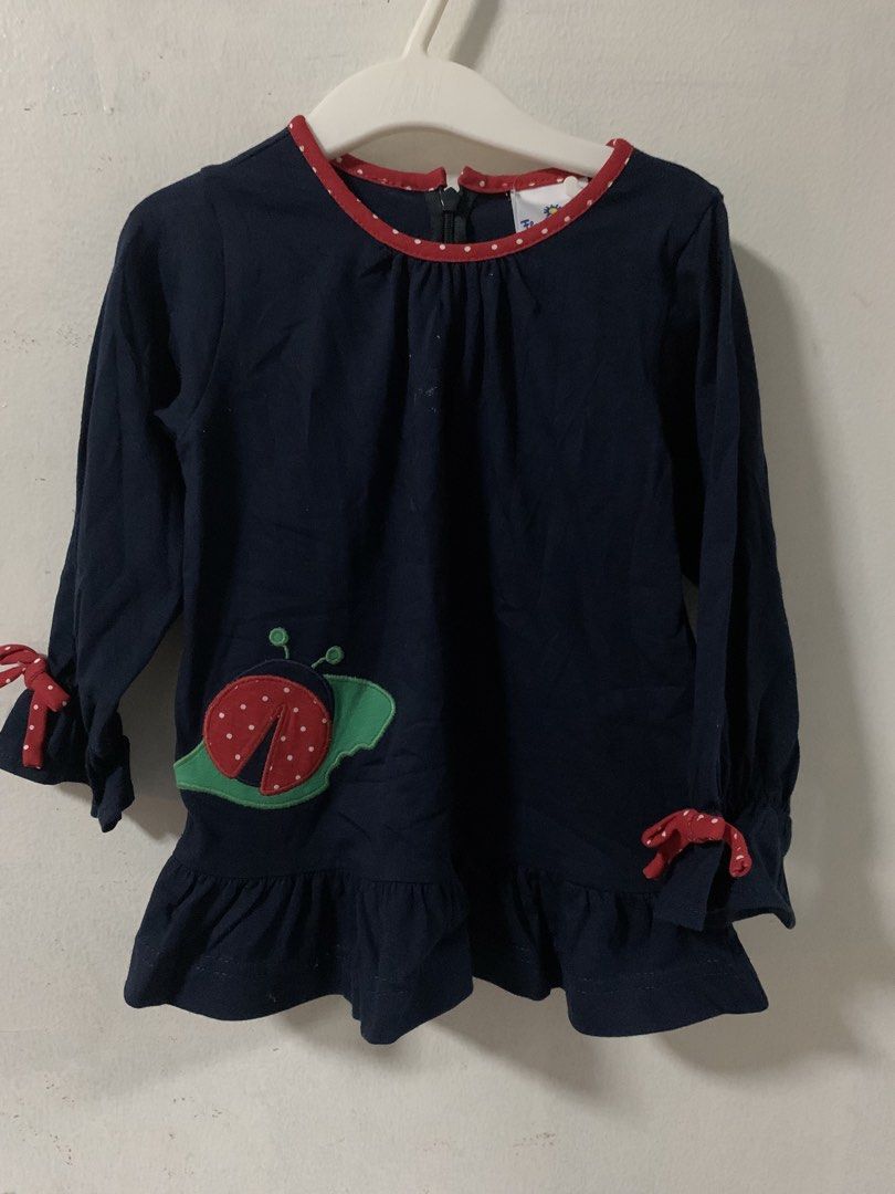 Navy Blue Ladybug Top with Red Trim - Size 3T (Category: Babies & Kids Fashion) located in Malabon City. Submitted by vewonica (Listing ID 1463779745, Image 1). Description: - Navy blue long-sleeved top for girls - Adorable ladybug applique on the front - Red polka dot trim on neckline and cuffs - Playful ruffled hem - Made in Colombia - Ideal for everyday wear.