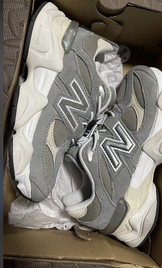 New Balance 9060 Grey White Sneakers (Category: Sneakers) located in Agdangan. Submitted by wardrobeblissprintcraft (Listing ID 1463883148, Image 1). Description: - Brand: New Balance - Model: 9060 - Color: Grey and White - Features: Classic N logo on the side, chunky sole design - Condition: Comes in original box with tissue paper - Ideal for: Everyday wear.