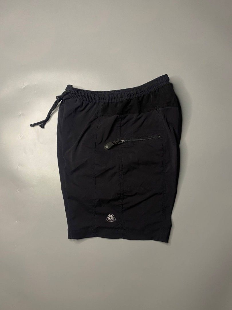 Nike ACG Black Cargo Shorts (Category: Shorts) located in Ajuy. Submitted by quickcrystal-effaca (Listing ID 1463875887, Image 1). Description: - Black Nike ACG shorts - Elastic waistband with drawstring - Zippered pockets (front and back) - ACG logo detail on leg - Ideal for outdoor activities and casual wear - Comfortable and durable material.