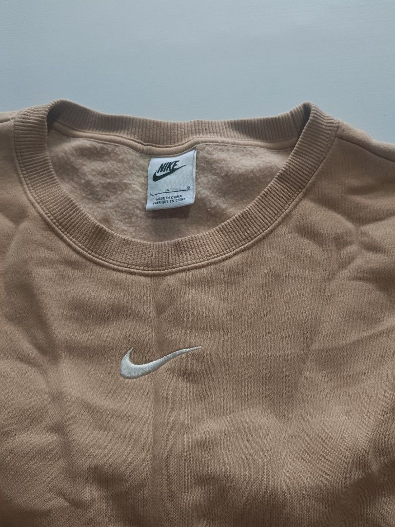 Nike Beige Crewneck Sweatshirt (Category: Coats, Jackets and Outerwear) located in Baguio. Submitted by wear_mo_clothing_shop (Listing ID 1463830008, Image 3). Description: - Classic beige Nike sweatshirt - Size: Large (L) - Features a small embroidered Swoosh logo on the chest - Crewneck style - Ribbed cuffs and hem for a comfortable fit - Versatile and perfect for everyday wear.