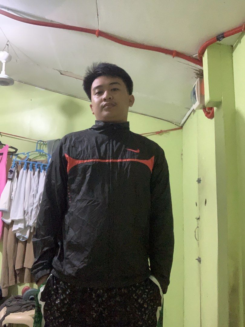 Nike Black Jacket with Red Accents (Category: Coats, Jackets and Outerwear) located in Alburquerque. Submitted by kentalicer (Listing ID 1463828238, Image 2). Description: - Nike jacket in black - Features a striking red stripe detail across the chest - Full zip closure for easy wear - Stylish stand-up collar - Lightweight, windbreaker-style material - Ideal for casual outings or light workouts - Great for staying comfortable in cooler weather Si