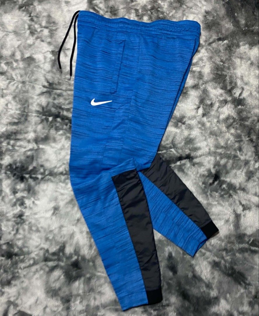 Nike Dri-Fit Blue Jogger Pants Size M (Category: Joggers) located in Sorsogon. Submitted by johnmichae69459 (Listing ID 1463869608, Image 1). Description: - Blue Nike Dri-Fit Jogger Pants - Size: Medium (M) - 30 to 34 waistline - 38 lenght - Made in China - Zippered side pocket for secure storage - Elastic waistband with adjustable drawstring - Black accents on lower legs - Ideal for workouts and casual wear.