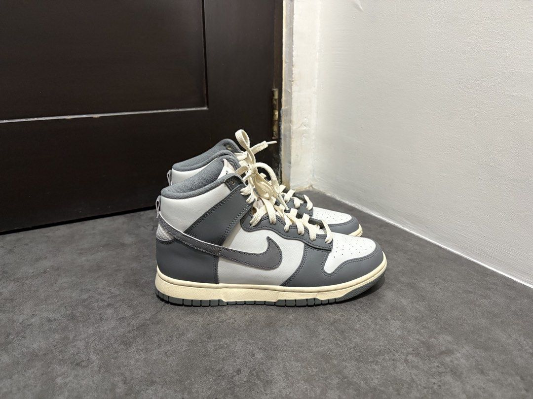 Nike Dunk High Grey White (Category: Sneakers) located in Taguig. Submitted by ernatrambulo10 (Listing ID 1463890414, Image 3). Description: - Classic Nike Dunk Highs - Grey and white colorway - Clean, high-top design - Cream-colored laces for contrast - Durable rubber sole for grip - Versatile for casual styling.