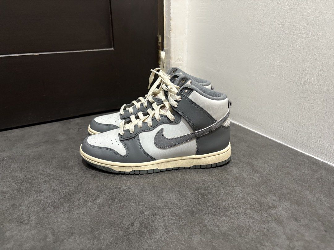 Nike Dunk High Grey White (Category: Sneakers) located in Taguig. Submitted by ernatrambulo10 (Listing ID 1463890414, Image 2). Description: - Classic Nike Dunk Highs - Grey and white colorway - Clean, high-top design - Cream-colored laces for contrast - Durable rubber sole for grip - Versatile for casual styling.
