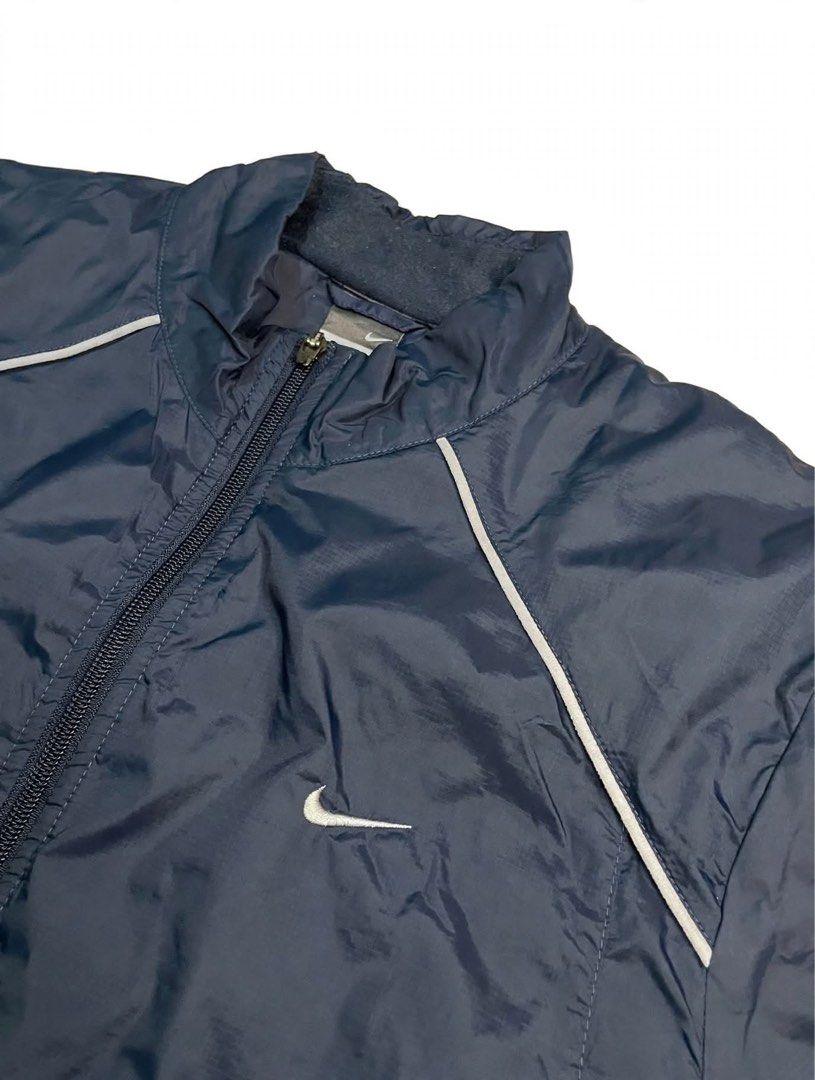 Nike Navy Blue Track Jacket XL (Category: Coats, Jackets and Outerwear) located in Santa Maria. Submitted by lftgcollective (Listing ID 1463911027, Image 2). Description: - Navy blue Nike track jacket - Size XL - Zip-up front with stand-up collar - White piping details on shoulders and sleeves - Two side pockets - Made in China.