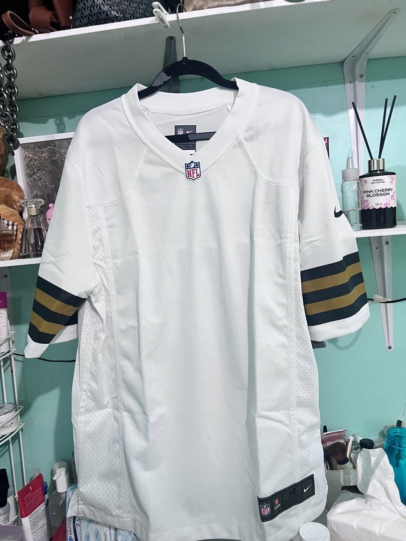 Nike NFL On Field Jersey - Size M (Category: Activewear) located in Manila. Submitted by cleverstone_21f597 (Listing ID 1463795586, Image 1). Description: - White Nike NFL Jersey - Size: Medium (M) - Features NFL shield logo - Includes Nike swoosh - Green and gold stripes on sleeves - Made in Indonesia - Ideal for any football fan.