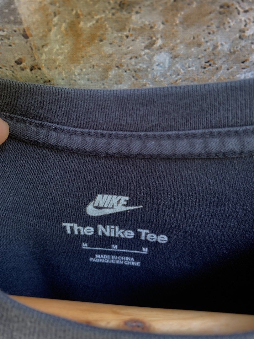 Nike "Swoosh By Nike" Tee - Black (Category: Tshirts & Polo Shirts ) located in Aloran. Submitted by chester78864 (Listing ID 1463903006, Image 3). Description: - Black Nike T-shirt, Size M - Features 'Swoosh By Nike' graphic and Nike Inc. address on the back - Small Nike logo and address on the front - Made of 100% cotton - Ideal for casual everyday wear.