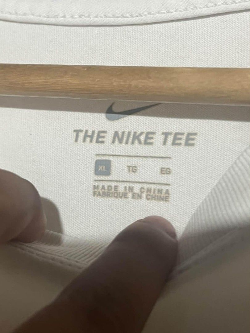 Nike Tee White with Red Lips Logo XL (Category: Tshirts & Polo Shirts ) located in Maasin. Submitted by trippythirftyyy (Listing ID 1463876072, Image 3). Description: - White Nike T-shirt - Size LARGE-XL (boxy fit) -Good Condition -washed and ready to wear - Features a small red lips graphic with a Nike swoosh - Made in China - Ideal for casual wear.