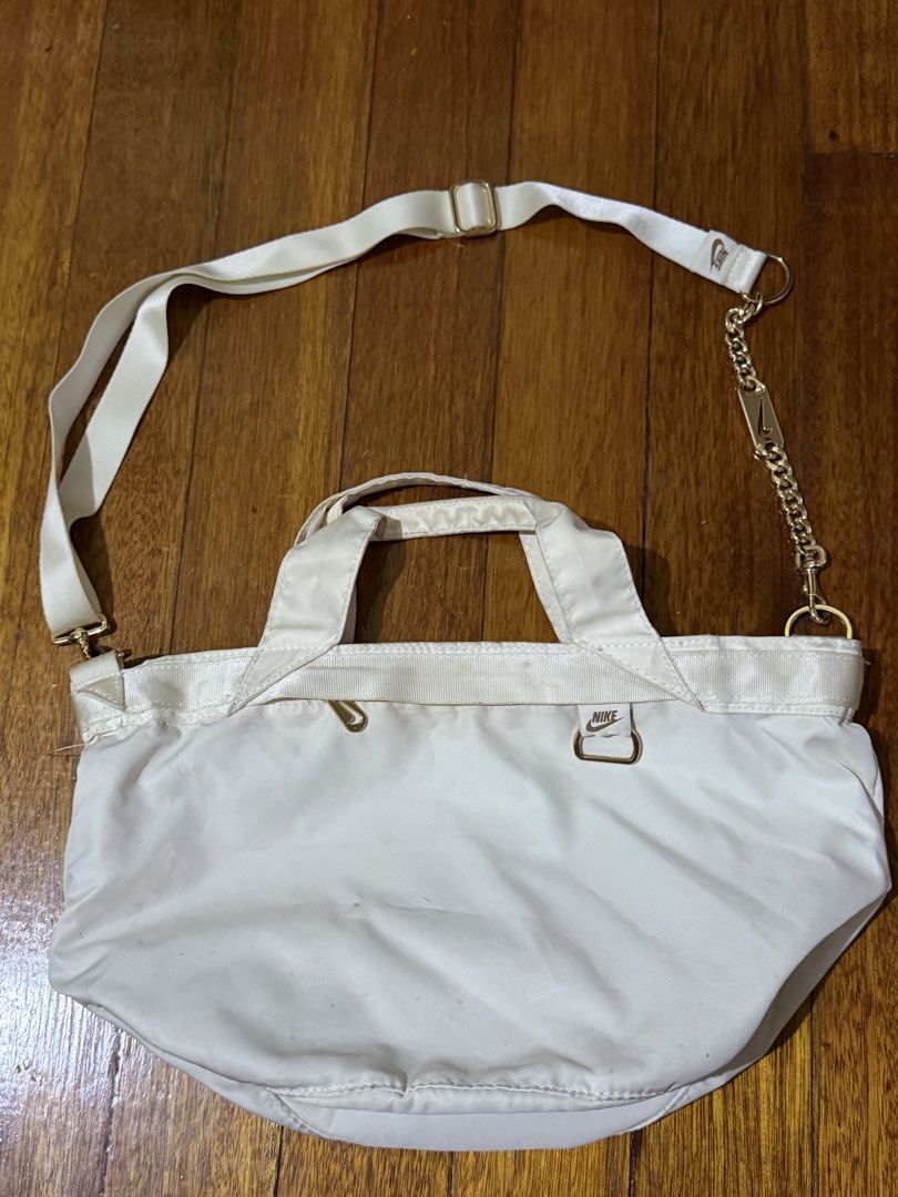 Nike Tote Bag with chain (Category: Tote Bags) located in Paranaque City. Submitted by declutternsell.729 (Listing ID 1463776615, Image 3). Description: - Cream-colored Nike tote bag - Zip-top closure for security - Interior zippered pocket for essentials - Comfortable top handles - Detachable crossbody strap with stylish gold chain accent - Perfect for daily use or travel - Shows minor signs of wear.