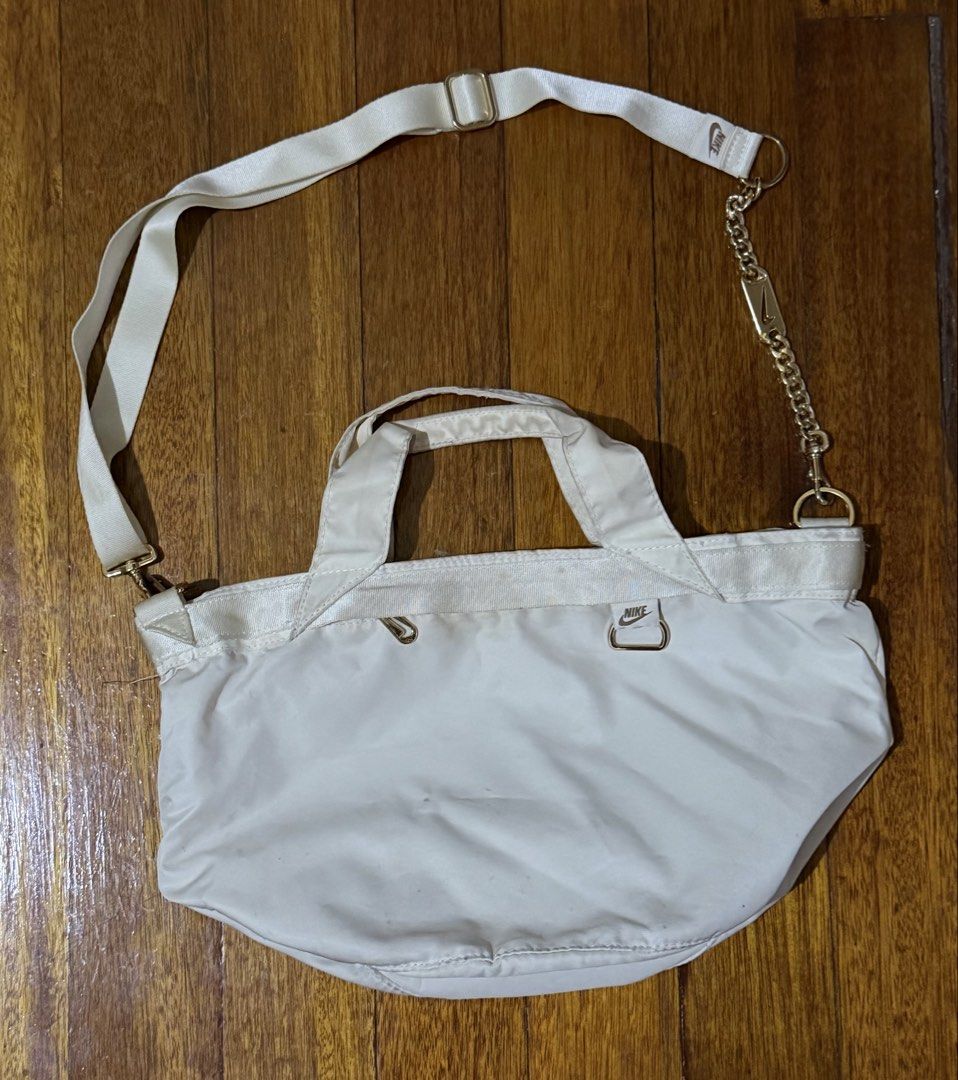 Nike Tote Bag with chain (Category: Tote Bags) located in Paranaque City. Submitted by declutternsell.729 (Listing ID 1463776615, Image 1). Description: - Cream-colored Nike tote bag - Zip-top closure for security - Interior zippered pocket for essentials - Comfortable top handles - Detachable crossbody strap with stylish gold chain accent - Perfect for daily use or travel - Shows minor signs of wear.