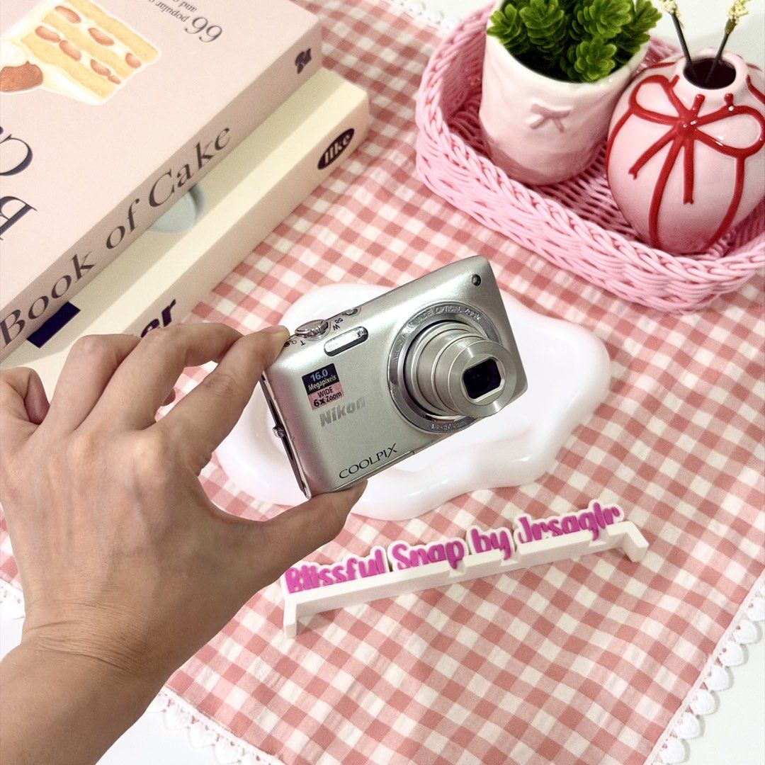 Nikon COOLPIX S2700 Digital Camera (Category: Cameras) located in Manila. Submitted by decluttered_by.kisses (Listing ID 1463805475, Image 3). Description: Model: Nik♡n Coolpix S2700 ♡₊˚ - one of the best seller! price: [🔖₱6,499 + SF 📦] ╰┈➤ comment “mine” 🛒 IG: Blissful.Snap FB Page: Blissful Snap Tiktok: Blissful.Snap 🌸 𝗱𝗲𝘁𝗮𝗶𝗹𝘀: 📸 – Key Features • 16 MP CCD sensor • 6× optical zoom • Compact point-and-shoot body • ISO 80–1600 • 720p 