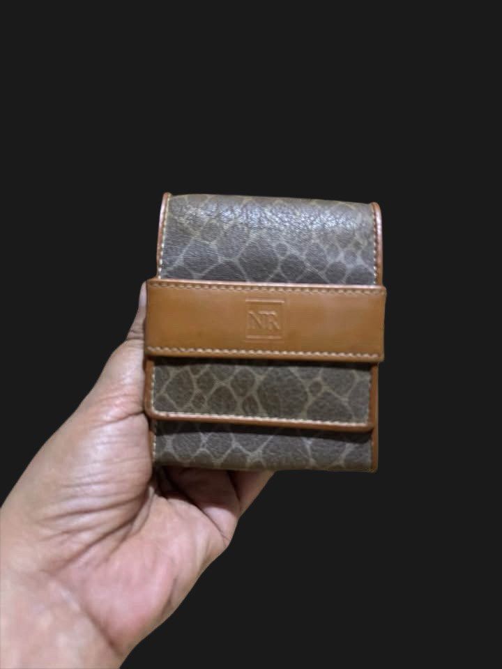 NINA RICCI Cigarette Pouch/Case Leather (Category: Luxury Bags & Wallets) located in Cabanatuan. Submitted by jennietomodachi (Listing ID 1463912972, Image 1). Description: vintage Nina Ricci small snap wallet or cigarette/card case featuring a brown and tan patterned design with an embossed “NR” logo on the front leather strap..