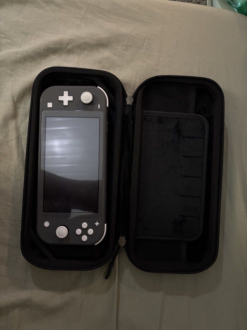 Nintendo Switch Lite with Carrying Case (Category: Nintendo) located in Manila. Submitted by sarmientom52880 (Listing ID 1463818632, Image 1). Description: - Nintendo Switch Lite (Grey) - Includes black protective carrying case - Case features mesh pocket for accessories and game slots - Comes with 256GB, SD card, Fornite edition.