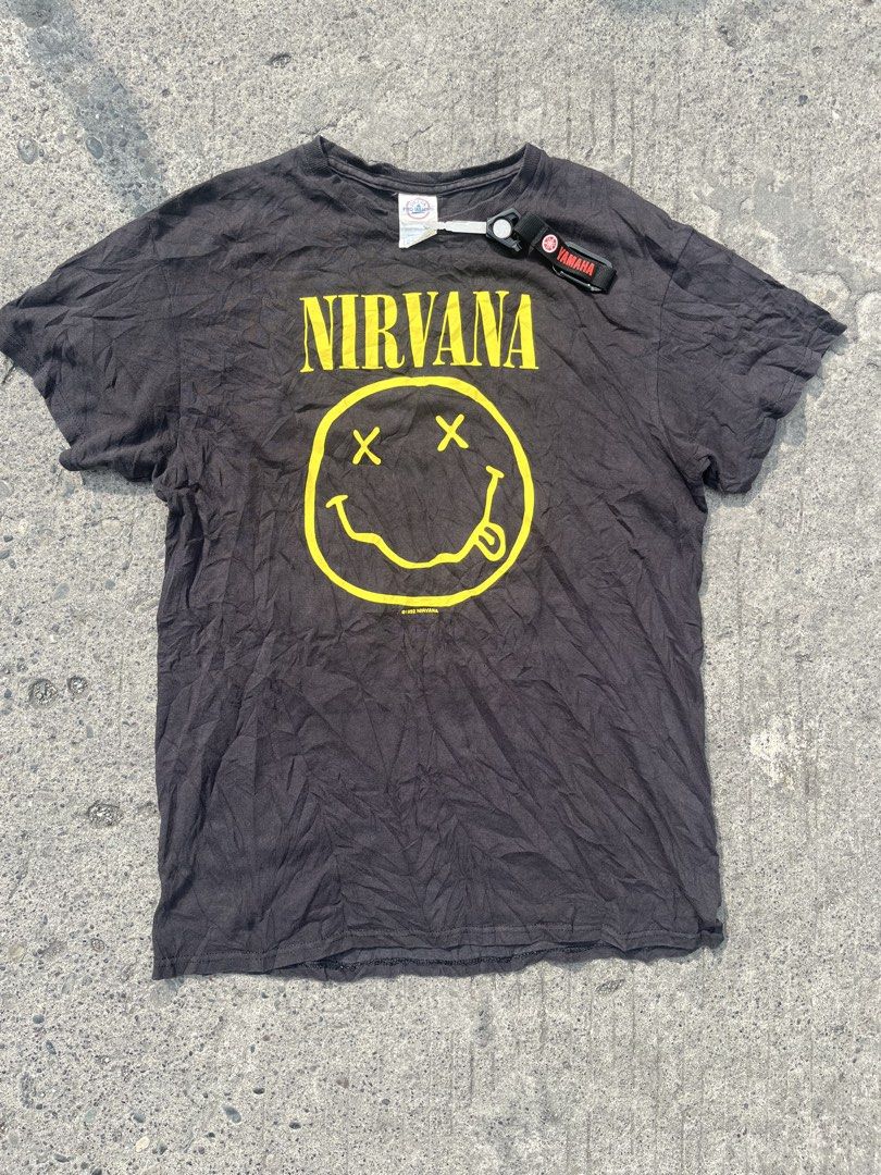 Nirvana Smiley Face T-Shirt Delta Pro Weight Size M (Category: Tshirts & Polo Shirts ) located in Davao. Submitted by notoriousthrift (Listing ID 1463796525, Image 1). Description: - Authentic Nirvana t-shirt with iconic smiley face logo on front. - Features printed lyrics on the back. - Made by Delta Pro Weight, 100% preshrunk cotton. - Tag size: Medium (M). -Dimes 20x27 - Made in Honduras. - A must-have for any Nirvana fan!.