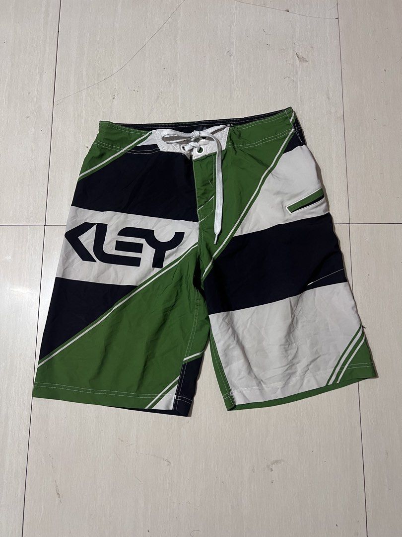 Oakley Board Shorts Green Black White Geometric Pattern (Category: Swim Trunks & Board Shorts) located in Zamboanga. Submitted by safe.haimer (Listing ID 1463882653, Image 1). Description: - Oakley board shorts -Size 30 -L21.5 - Green, black, and white geometric design - Drawstring waist for adjustable fit - Convenient zippered pocket on the side - Ideal for swimming, surfing, or lounging - Made from a comfortable polyester and spandex blend.