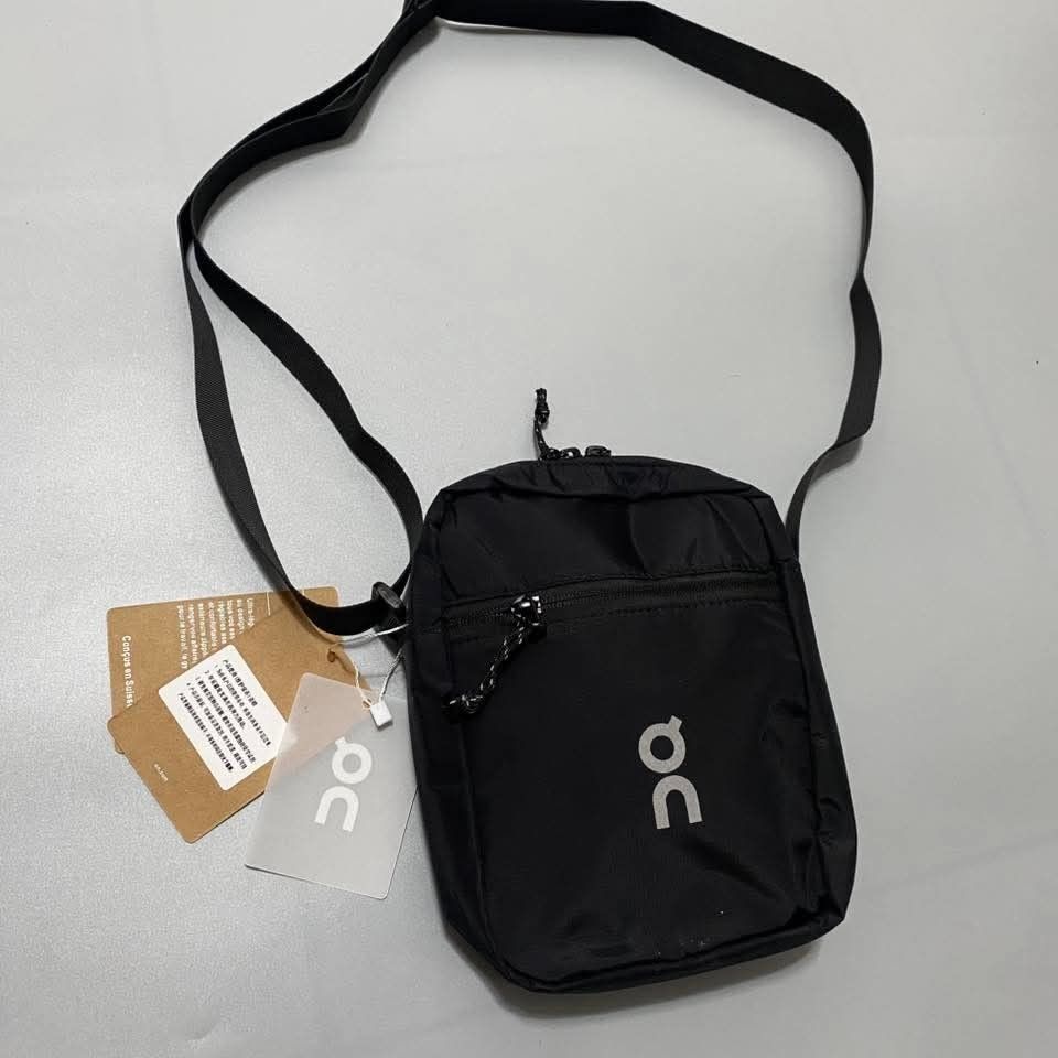ON Running Black Crossbody Bag (Category: Cross-body Bags) located in Victoria. Submitted by wearnsel (Listing ID 1463806174, Image 1). Description: - Brand: ON Running - Color: Black - Style: Crossbody bag - Size: Small and compact - Features: Main zippered compartment, inner pocket, adjustable strap - Condition: Brand new with tags attached - Ideal for: Daily use, travel, carrying essentials - Bought in Australia.