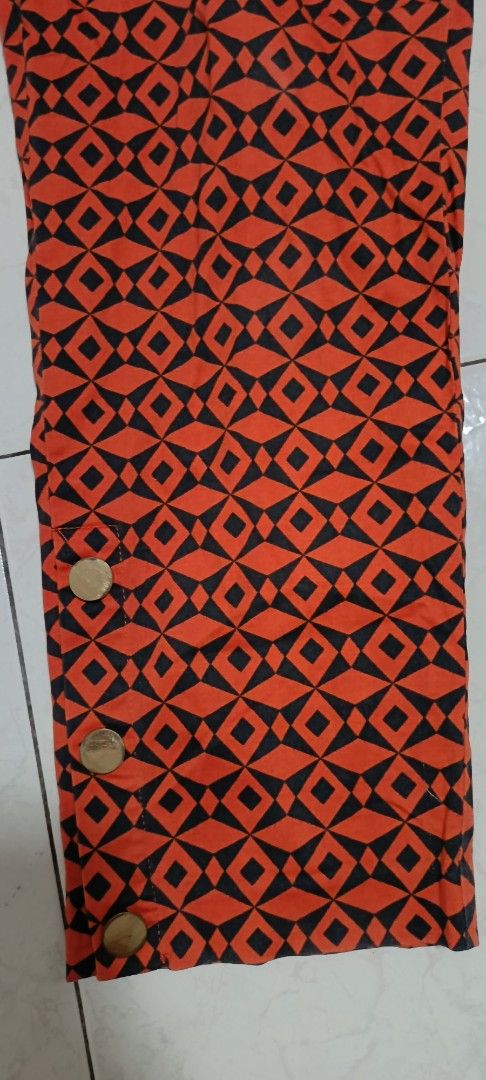 Orange and Black Geometric Pattern Pants with Button Detail size 40 (Category: Jeans) located in Paranaque City. Submitted by yesyesyo (Listing ID 1463813210, Image 3). Description: - Eye-catching orange and black geometric print - Trendy cropped length - Stylish button details on the side of the leg - Versatile for casual outfits - Easy to mix and match with your wardrobe -Width 20 inches - Length 40 inches this is not thrifted. all are for decl
