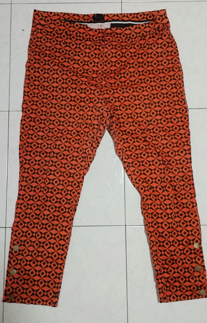 Orange and Black Geometric Pattern Pants with Button Detail size 40 (Category: Jeans) located in Paranaque City. Submitted by yesyesyo (Listing ID 1463813210, Image 2). Description: - Eye-catching orange and black geometric print - Trendy cropped length - Stylish button details on the side of the leg - Versatile for casual outfits - Easy to mix and match with your wardrobe -Width 20 inches - Length 40 inches this is not thrifted. all are for decl