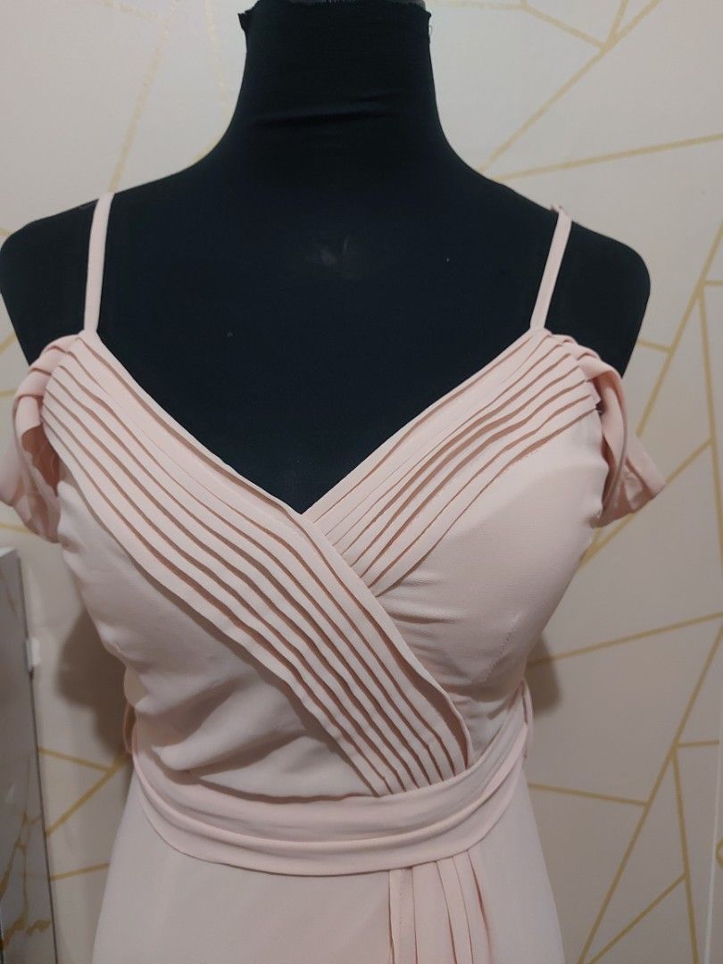 Peach Cold Shoulder Pleated Maxi Dress(small) (Category: Dresses) located in Manila. Submitted by jollyann_b1990 (Listing ID 1463812042, Image 3). Description: - Beautiful peach maxi dress - Cold shoulder design with short sleeves - Flattering V-neckline with pleated detailing - Cinched waist with a tie for a defined silhouette - Flowy skirt for graceful movement - Convenient back zipper closure - Ideal for events and formal occasions.
