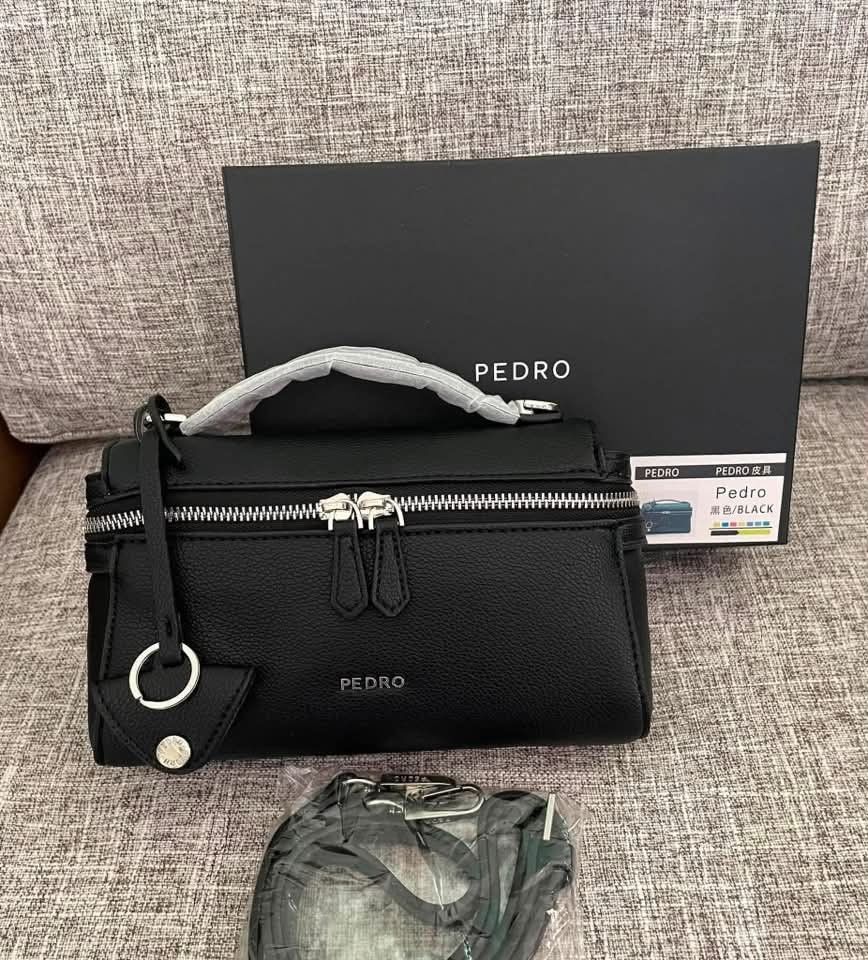 Pedro Top Handle Bag with Shoulder Strap (Category: Luxury Bags & Wallets) located in Manila. Submitted by cherylbela18304 (Listing ID 1463856048, Image 2). Description: - Pedro top handle bag - Comes with a detachable shoulder strap - Secure zip closure - Convenient top handle - Versatile for everyday use or evening events P1,500 Only! With dust bag Add P60 for paper bag, perfect for gift. ‼️Actual Photo Posted‼️.