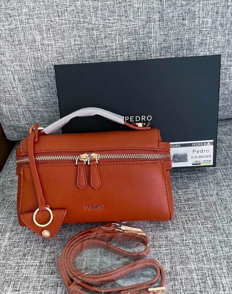 Pedro Top Handle Bag with Shoulder Strap (Category: Luxury Bags & Wallets) located in Manila. Submitted by cherylbela18304 (Listing ID 1463856048, Image 3). Description: - Pedro top handle bag - Comes with a detachable shoulder strap - Secure zip closure - Convenient top handle - Versatile for everyday use or evening events P1,500 Only! With dust bag Add P60 for paper bag, perfect for gift. ‼️Actual Photo Posted‼️.