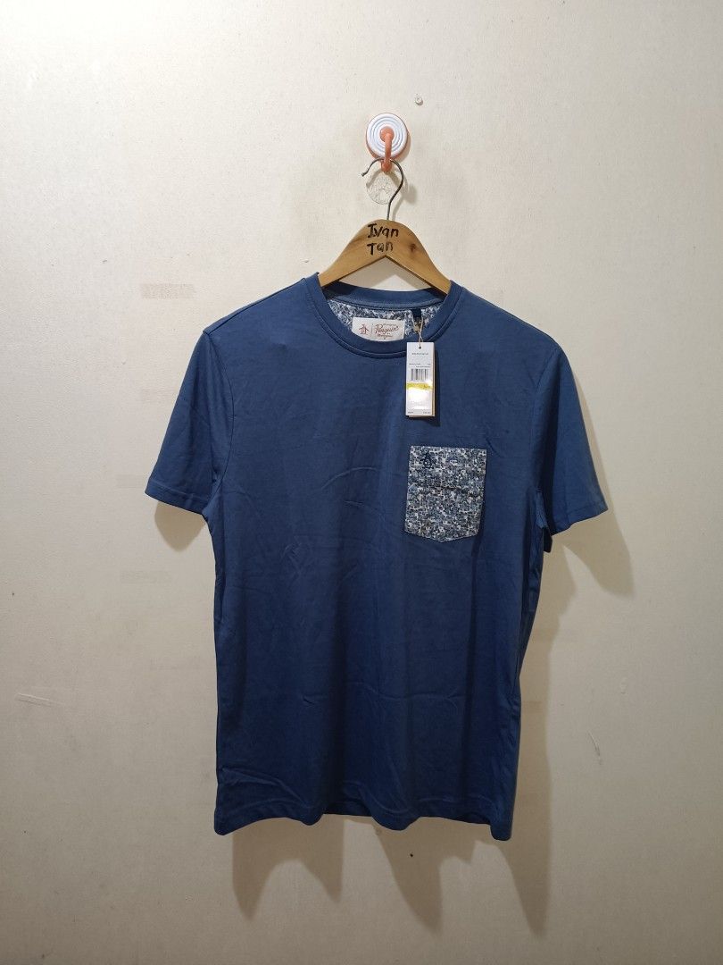 Penguin Pocket Tee (Category: Tshirts & Polo Shirts ) located in Makati City. Submitted by ivsseyow03 (Listing ID 1463748491, Image 1). Description: Blue t-shirt from Original Penguin. Made of 100% cotton. Features a patterned pocket on the chest. Tag still attached. Great for casual wear. Machine wash cold. Made in Vietnam..
