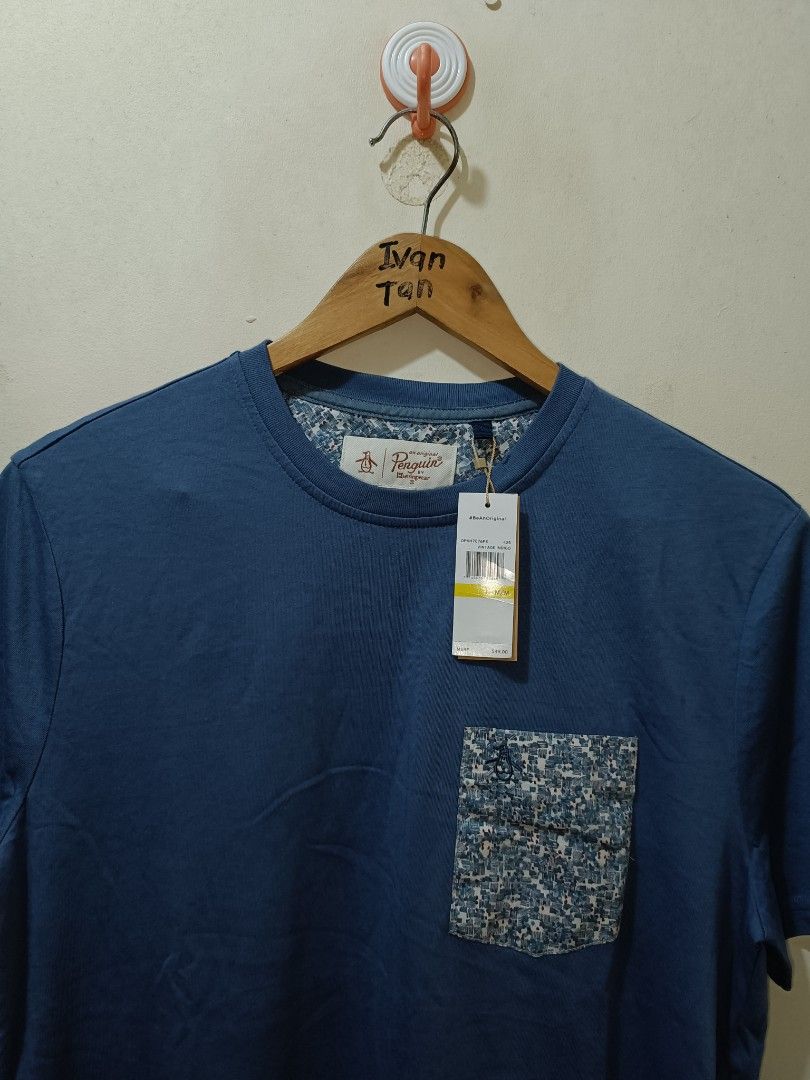 Penguin Pocket Tee (Category: Tshirts & Polo Shirts ) located in Makati City. Submitted by ivsseyow03 (Listing ID 1463748491, Image 2). Description: Blue t-shirt from Original Penguin. Made of 100% cotton. Features a patterned pocket on the chest. Tag still attached. Great for casual wear. Machine wash cold. Made in Vietnam..