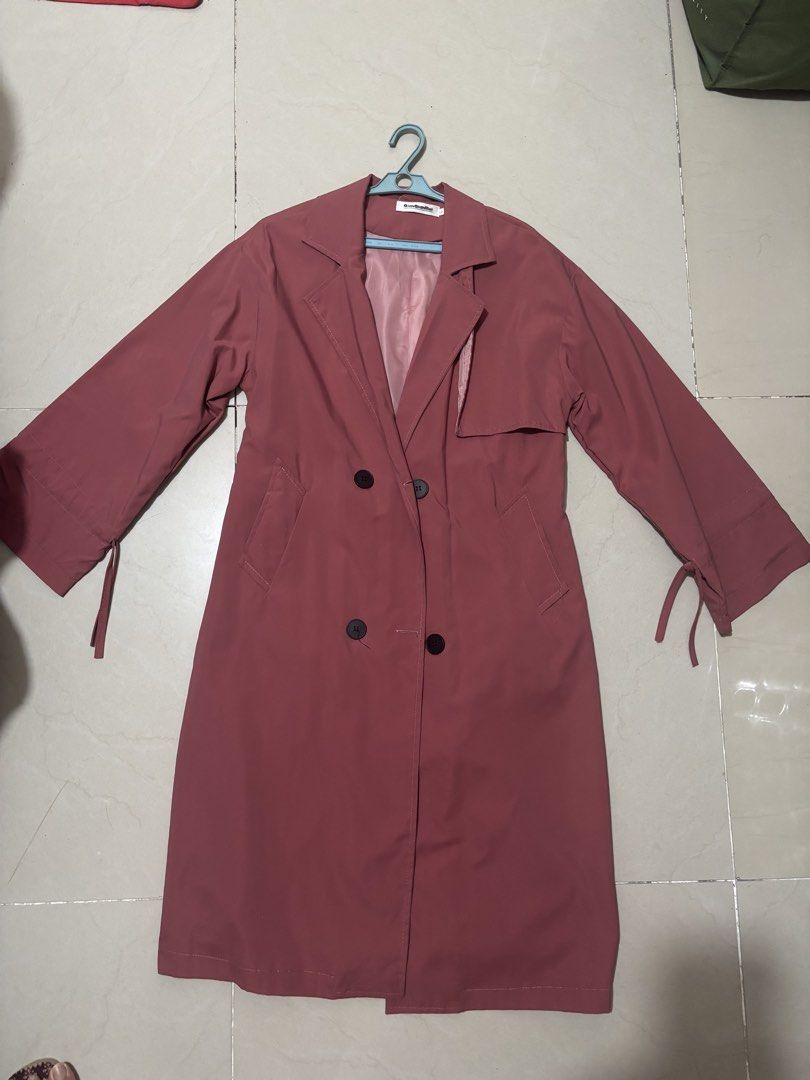 Pink Double-Breasted Long Trench Coat (Category: Coats, Jackets and Outerwear) located in Manila. Submitted by declutterwithbeyuh (Listing ID 1463770609, Image 2). Description: - Lovely pink long trench coat - Double-breasted with black buttons - Functional front pockets - Unique tie details at sleeve cuffs - Lightweight material, ideal for layering - Perfect for cooler weather.