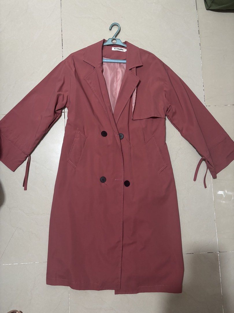 Pink Double-Breasted Long Trench Coat (Category: Coats, Jackets and Outerwear) located in Manila. Submitted by declutterwithbeyuh (Listing ID 1463770609, Image 1). Description: - Lovely pink long trench coat - Double-breasted with black buttons - Functional front pockets - Unique tie details at sleeve cuffs - Lightweight material, ideal for layering - Perfect for cooler weather.