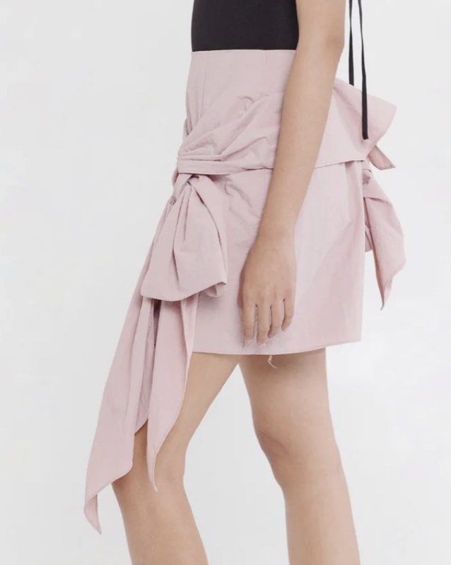 Pink Drape Tie Front Mini Skirt (Category: Skirts) located in Mandaluyong City. Submitted by youarecutejeans (Listing ID 1463813427, Image 3). Description: - Cute pink mini skirt - Unique drape and tie front detail - Textured fabric for a nice feel - Versatile: dress up or down - Perfect for nights out or casual days - Zipper closure at the back.
