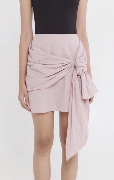 Pink Drape Tie Front Mini Skirt (Category: Skirts) located in Mandaluyong City. Submitted by youarecutejeans (Listing ID 1463813427, Image 1). Description: - Cute pink mini skirt - Unique drape and tie front detail - Textured fabric for a nice feel - Versatile: dress up or down - Perfect for nights out or casual days - Zipper closure at the back.