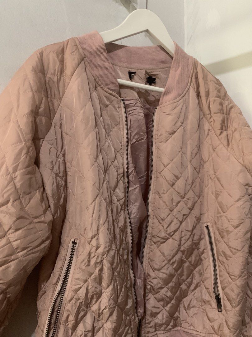 Pink Quilted Bomber Jacket (Category: Coats, Jackets and Outerwear) located in Manila. Submitted by spaceshop12345 (Listing ID 1463806839, Image 2). Description: - Light pink quilted bomber jacket - Zip-up front closure - Two side zip pockets - Ribbed collar, cuffs, and hem - Ideal for casual layering and easy styling.