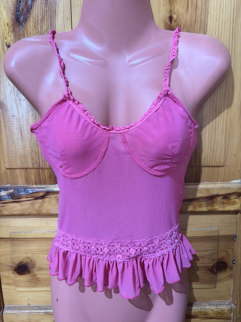 Pink Ruffled Mesh Bralette Top with Lace Trim (Category: Sleeveless) located in Baguio. Submitted by declutterbycys (Listing ID 1463821097, Image 1). Description: - Adorable pink top with ruffled mesh details. - Features adjustable straps for a perfect fit. - Decorative lace band at the waist. - Supportive design in the bust area. - Versatile: great for layering or wearing on its own. - Fun and flirty style..