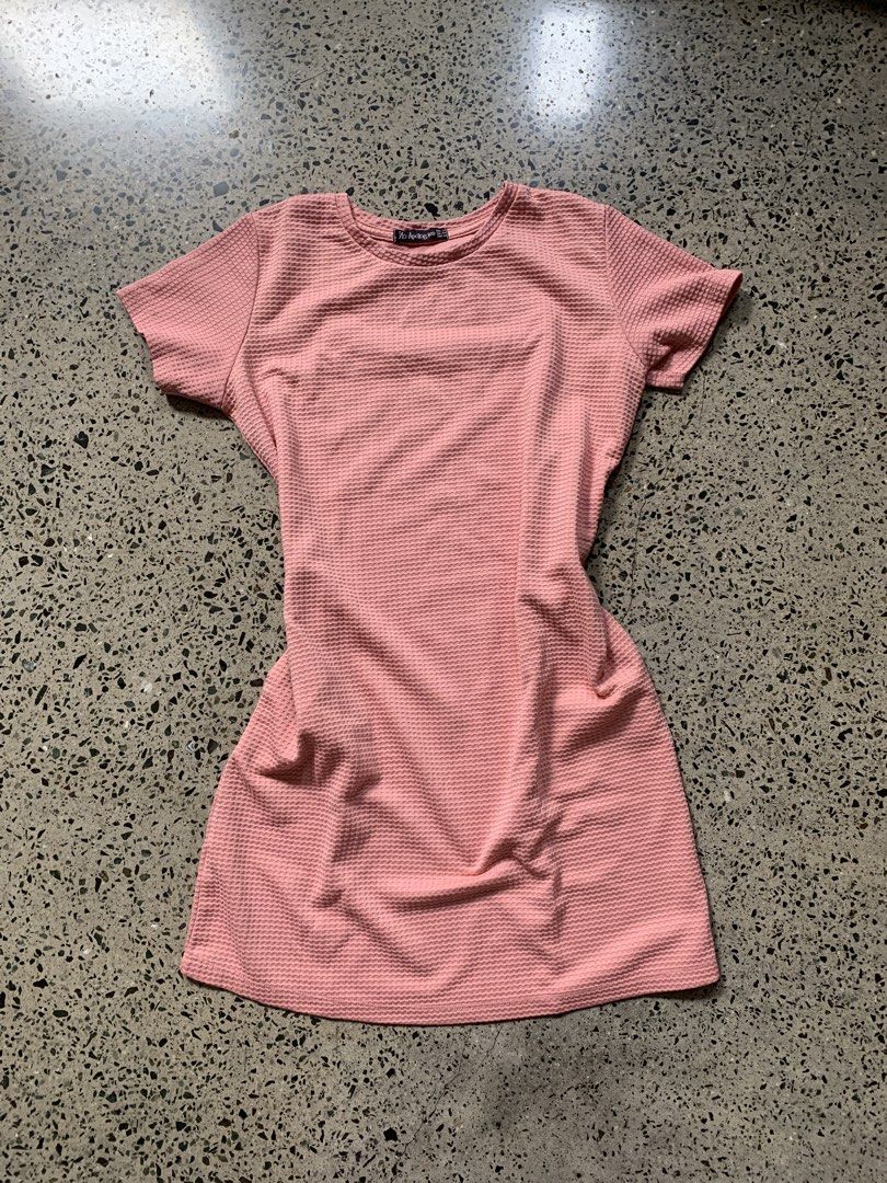Pink Textured Short Sleeve Dress (Category: Dresses) located in Quezon City. Submitted by p.j.c.a.r.o.u.s.e.l.l.i.n.g (Listing ID 1463787721, Image 1). Description: - Adorable pink dress - Textured fabric with a subtle waffle pattern - Short sleeves - Classic crew neck - Versatile for casual outings or dressing up - Effortless to style.
