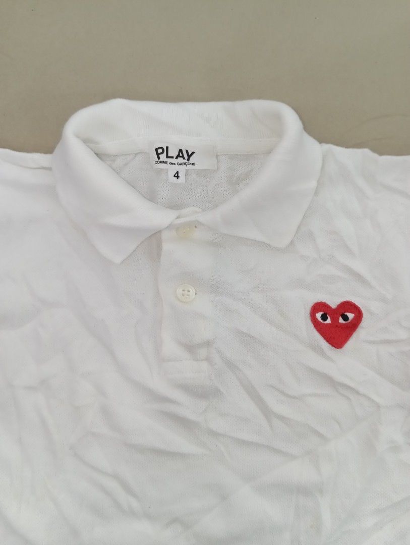 PLAY CDG kids polo (authentic/original) (Category: Babies & Kids Fashion) located in Manila. Submitted by brugodoy (Listing ID 1463789882, Image 3). Description: - Brand: PLAY COMME des GARÇONS - Color: White - Style: Short-sleeved polo shirt - Features: Iconic red heart logo on chest, two-button placket collar - Size: 4 - Occasion: Casual wear.