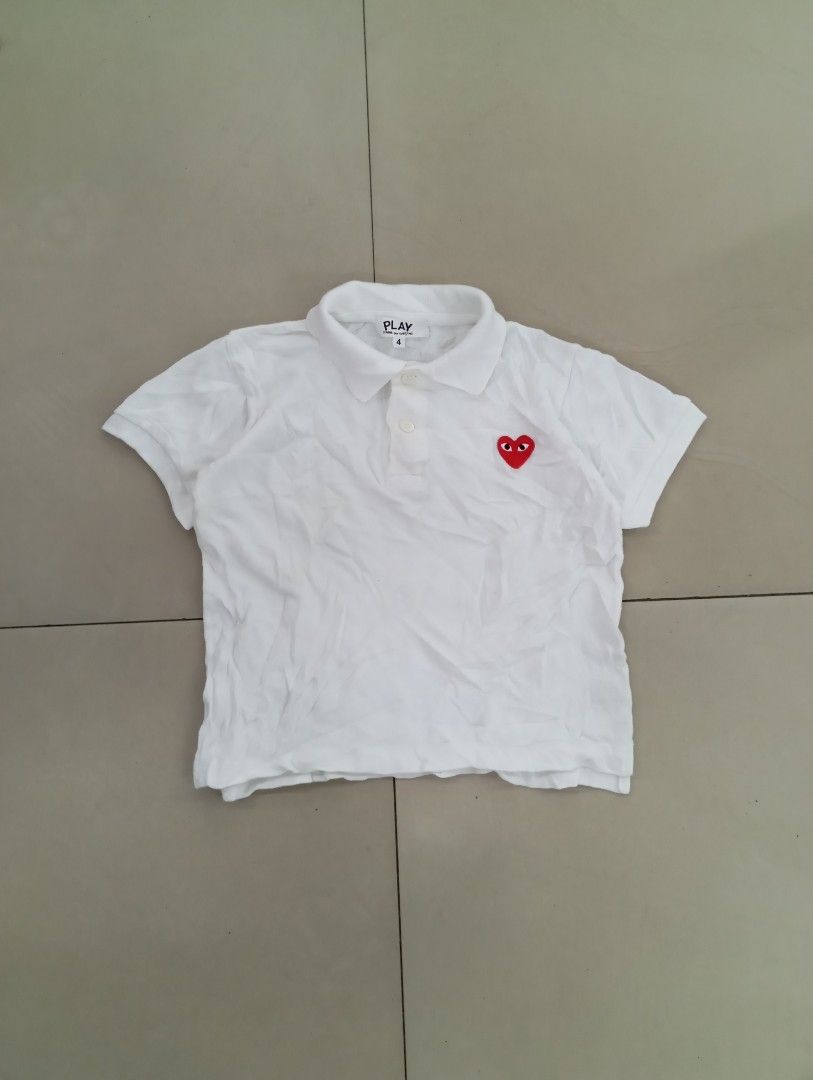 PLAY CDG kids polo (authentic/original) (Category: Babies & Kids Fashion) located in Manila. Submitted by brugodoy (Listing ID 1463789882, Image 2). Description: - Brand: PLAY COMME des GARÇONS - Color: White - Style: Short-sleeved polo shirt - Features: Iconic red heart logo on chest, two-button placket collar - Size: 4 - Occasion: Casual wear.