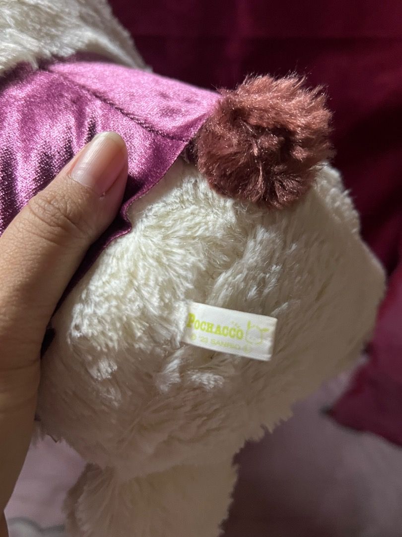Pochacco Plush Dog Sanrio (Category: Plushies & Soft Toys) located in Bulacan. Submitted by haven_plushie_dolls.888 (Listing ID 1463844563, Image 3). Description: - Adorable Pochacco plush toy - Cream color with brown ears and tail - Features a sparkly purple vest with a satin bow - Super soft and cuddly - Ideal for Sanrio collectors and fans - Great for decoration or playtime.