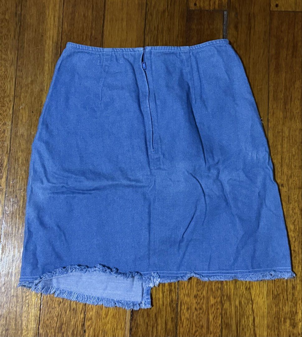 Pois Denim Skirt Size S (Category: Skirts) located in Paranaque City. Submitted by declutternsell.729 (Listing ID 1463773805, Image 3). Description: - Pois blue denim skirt - Size S - Raw hem detail - Distressed front seam - Zipper closure at the back - Fun and casual, great for everyday wear.