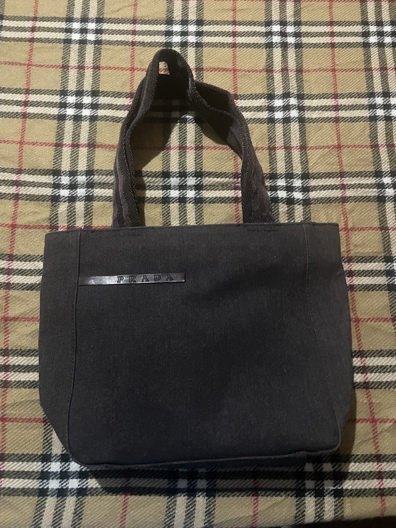 PRADA Canvas Handbag (Category: Luxury Bags & Wallets) located in Iligan City. Submitted by ileganteph (Listing ID 1463825240, Image 1). Description: Prada Logo Outside Prada Metal Plate Inside Holo Inner Lining No major flaws.