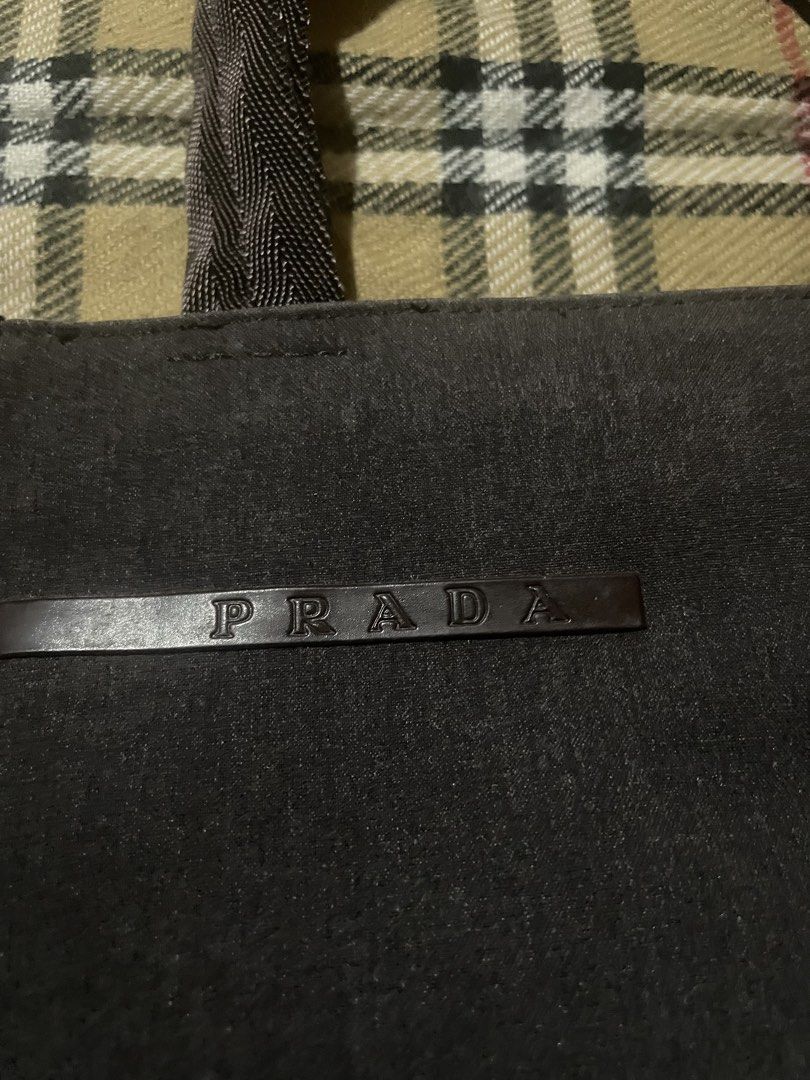 PRADA Canvas Handbag (Category: Luxury Bags & Wallets) located in Iligan City. Submitted by ileganteph (Listing ID 1463825240, Image 2). Description: Prada Logo Outside Prada Metal Plate Inside Holo Inner Lining No major flaws.