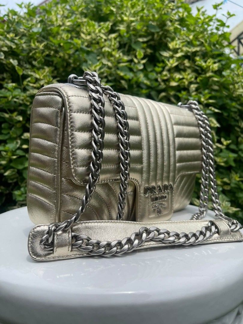 Prada Diagramme chain bag (Category: Luxury Bags & Wallets) located in Manila. Submitted by rangya (Listing ID 1463774183, Image 2). Description: - Metallic gold Prada shoulder bag - Classic quilted design - Silver chain strap - Prominent Prada Milano logo on front flap - Ideal for dressing up outfits.
