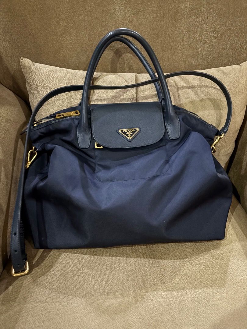 Prada Nylon Bag (Category: Luxury Bags & Wallets) located in Quezon City. Submitted by icecreammonster (Listing ID 1463866354, Image 2). Description: Prada Nylon Bag With shoulder straps Color: Navy Blue Has minor cracks on the leather straps.