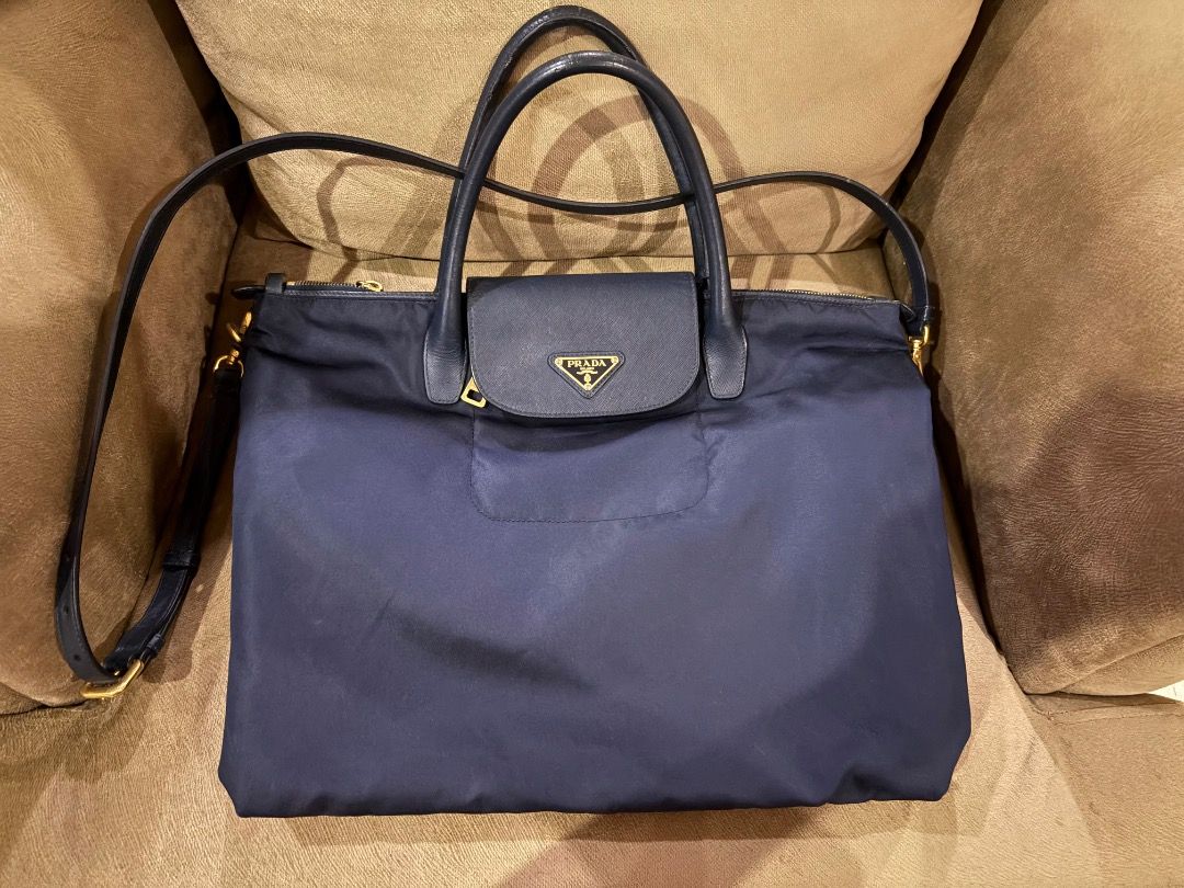 Prada Nylon Bag (Category: Luxury Bags & Wallets) located in Quezon City. Submitted by icecreammonster (Listing ID 1463866354, Image 1). Description: Prada Nylon Bag With shoulder straps Color: Navy Blue Has minor cracks on the leather straps.